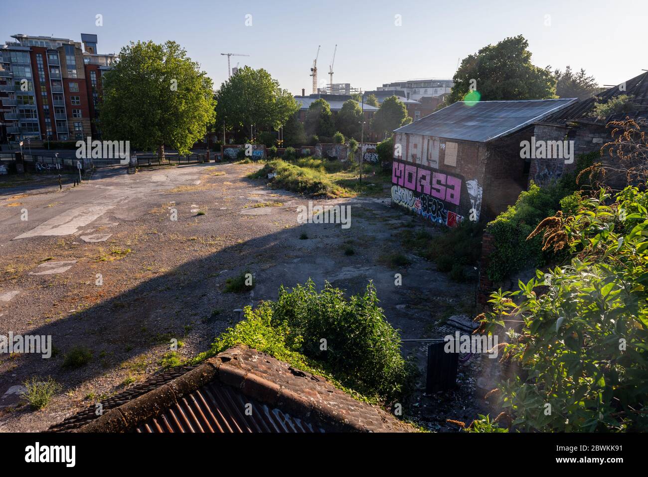 Bristol, England, UK - May 25, 2020: Dawn light falls on derelict buildings and an empty wasteground at Redcliffe Wharf, one of the last post-industri Stock Photo