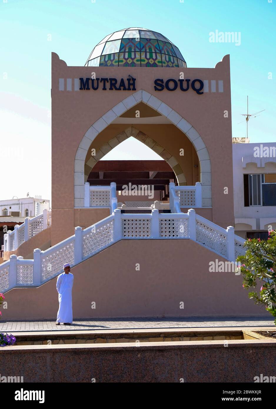 Local Omani man waiting outside Corniche entrance of the Mutrah Souq in Muscat, Sultanate of Oman Stock Photo