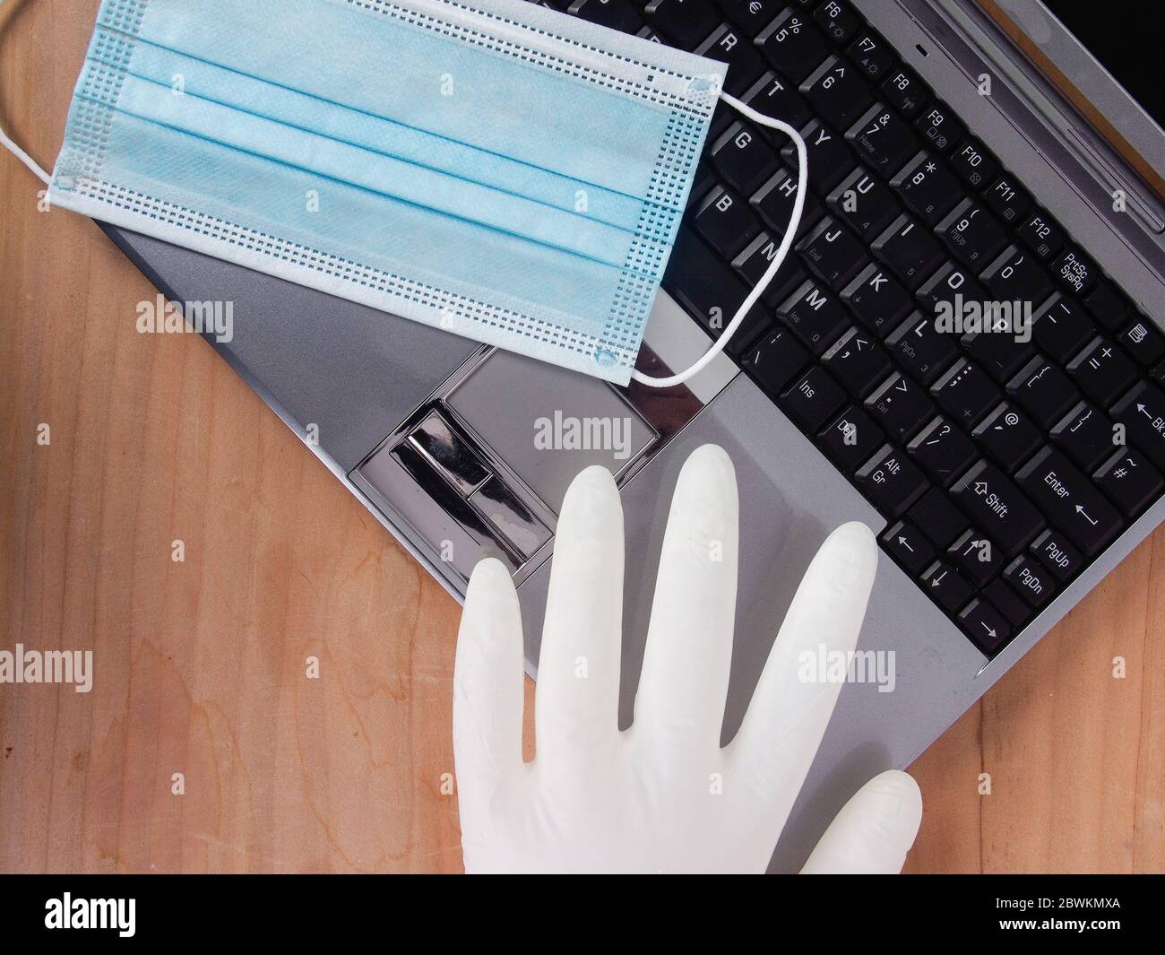 Workplace At Home For Remote Work Smart Working In New Normal Everyday With Lsilver Laptop On Wood Table And Face Mask Solution Against Spread Of Stock Photo Alamy