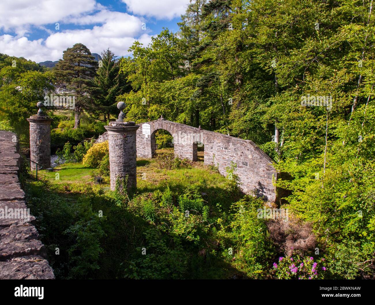 Killin, Scotland, UK - June 6, 2011: Sun shines on the Clan Macnab Burial Ground on an island in the River Dochart at Killin in the Highlands of Scotl Stock Photo