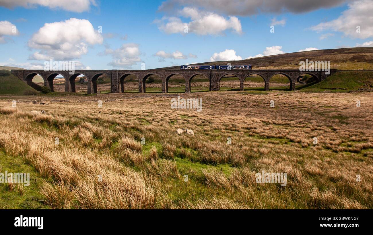 Carlisle, England - May 24, 2011: A Northern Rail Class 158 diesel passenger train crossing Dandry Mire Viaduct on the Settle-Carlisle Railway in the Stock Photo