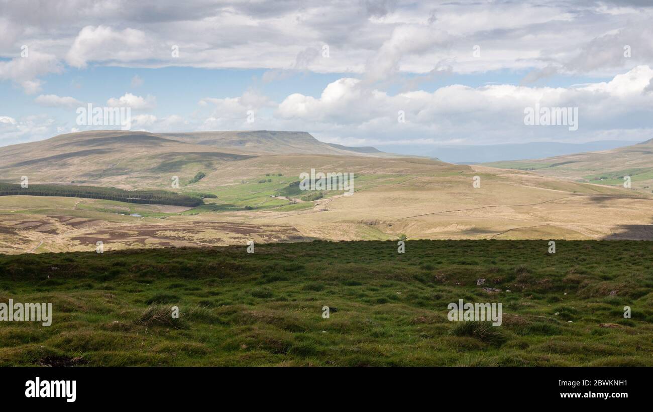 Sun shines on the high moorland of Wild Boar Fell and the valleys of Eden and Garsdale in the Yorkshire Dales hills. Stock Photo