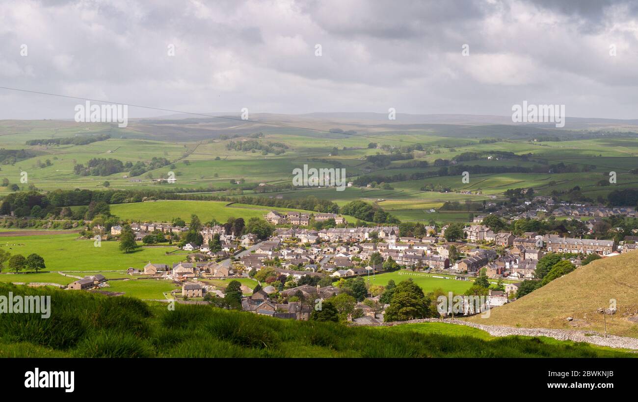 Sun shines on the houses of Settle town nestled in Ribblesdale valley