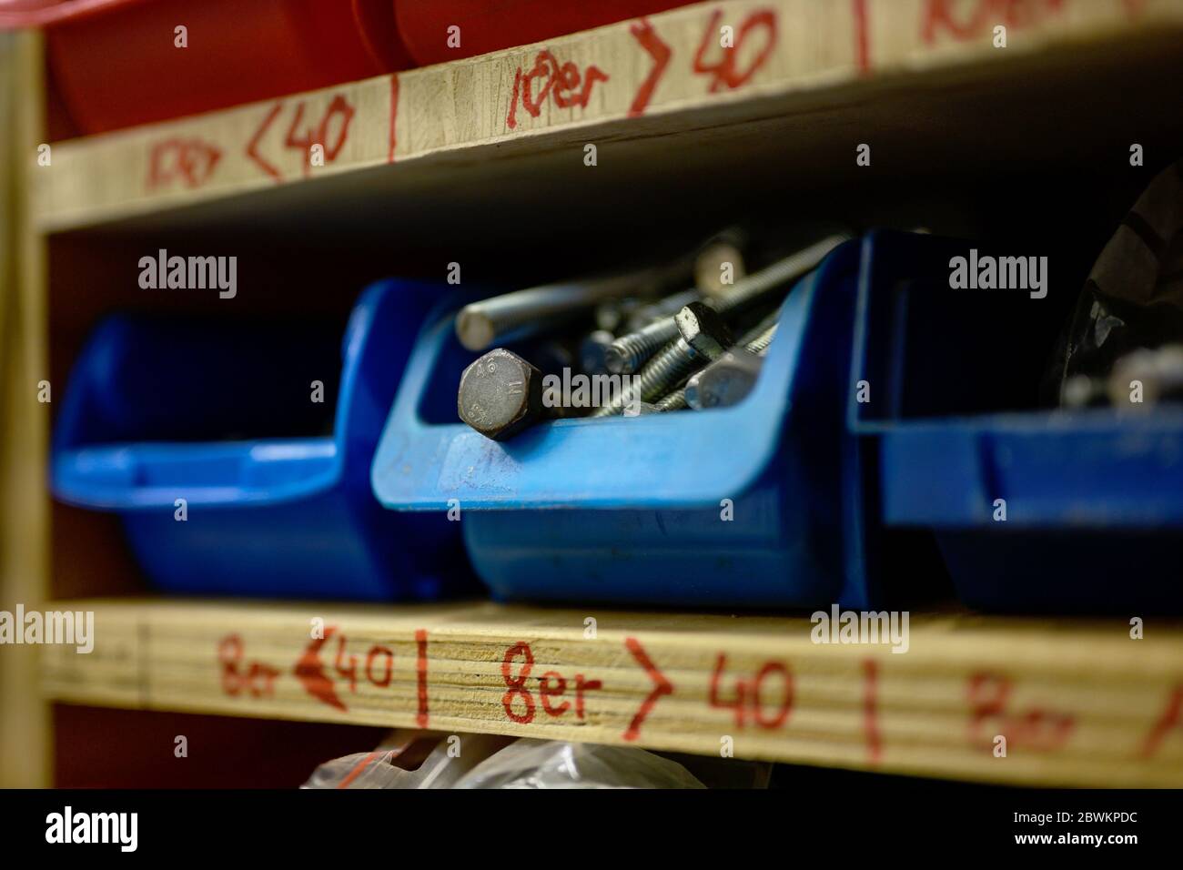 shelf with plastic drawers for different screws in a craftsman workshop, selected focus, very narrow depth of field Stock Photo