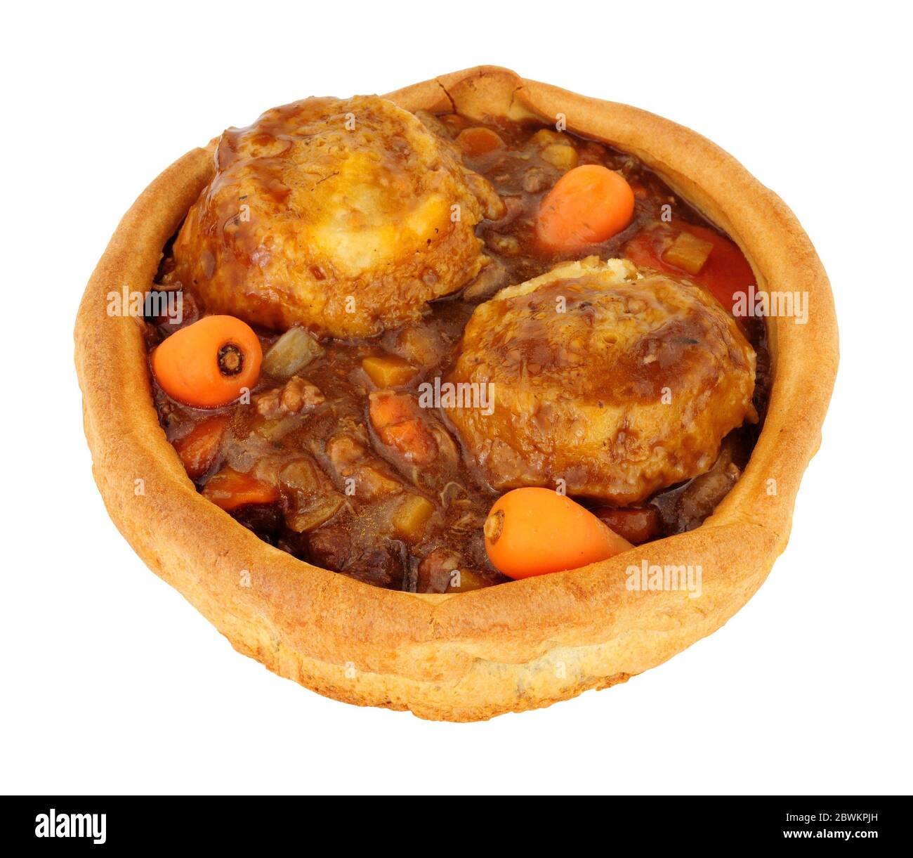 Beef and vegetable stew with dumplings in a large Yorkshire pudding