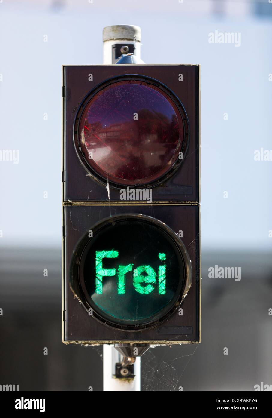 Traffic light is green and showing the german word „Frei“ translating to „free“ Stock Photo
