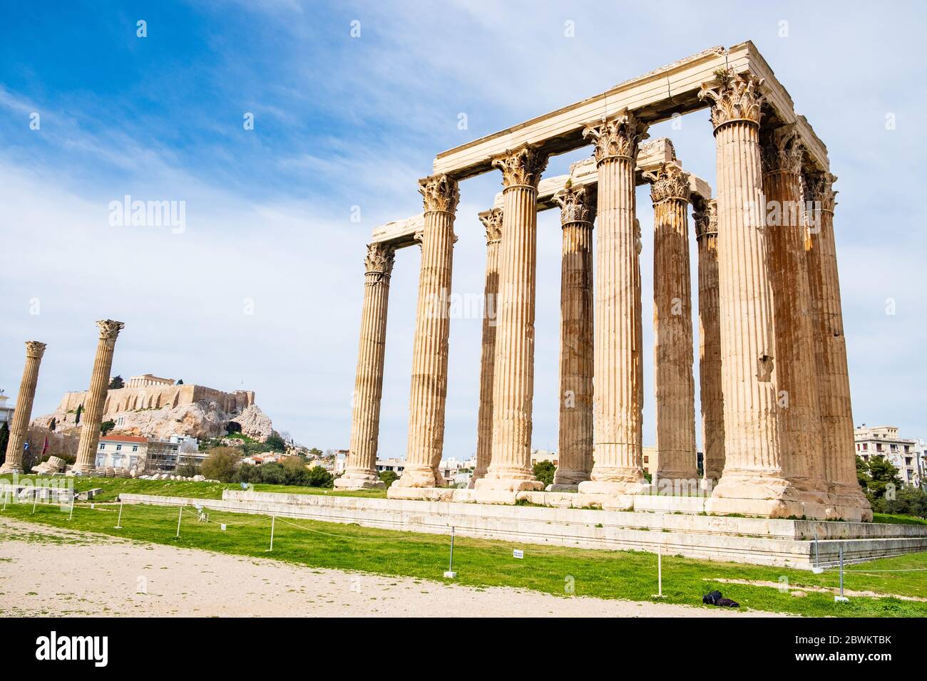 Ruins of the ancient Temple of Olympian Zeus in Athens (Olympieion or Columns of the Olympian Zeus) with Acropolis hill in the background Stock Photo
