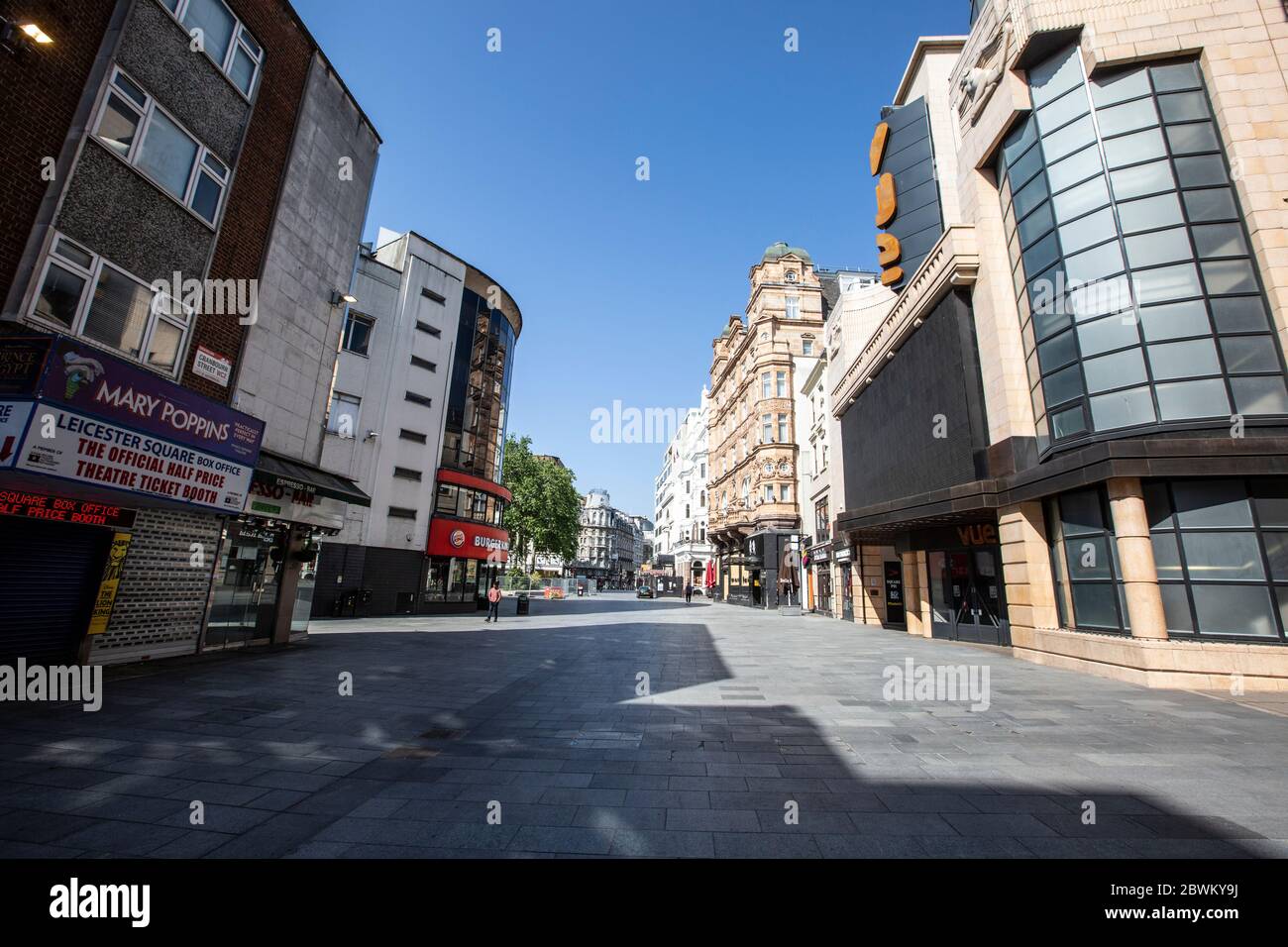 Empty streets of Leicester Square area of the West End in London during the coronavirus lockdown restrictions where businesses are unable to open, UK Stock Photo