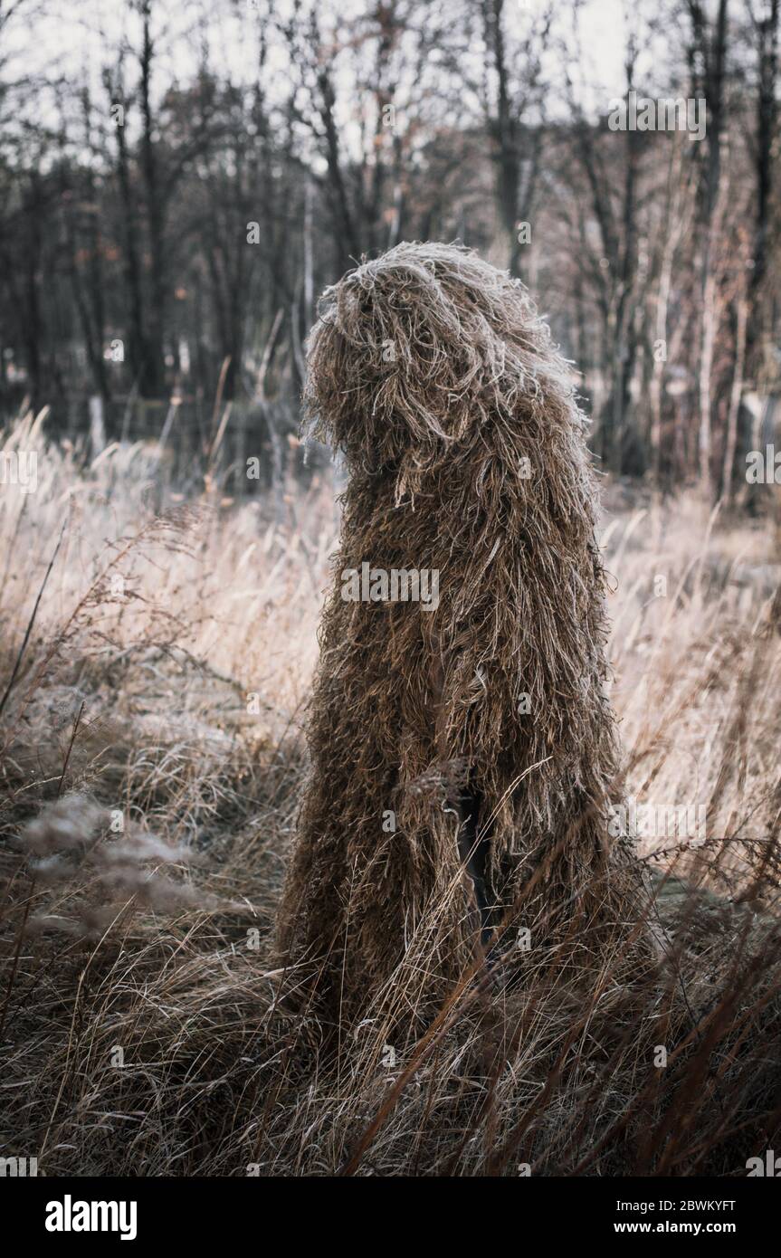 Special camouflage ghillie suit for military, snipers and intelligence agents. In field conditions. Stock Photo