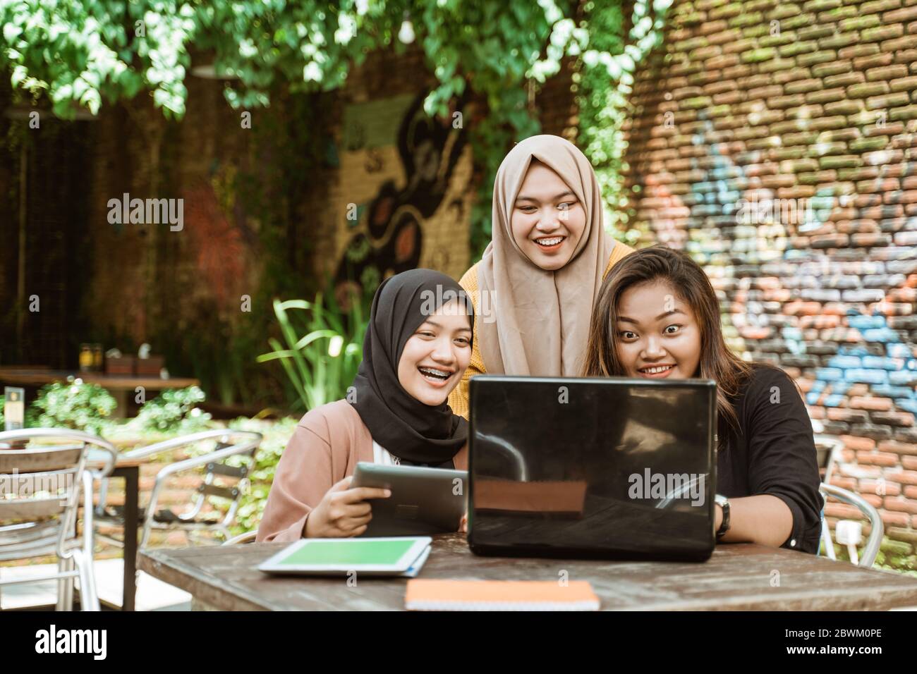 Asian group of students learning together using book and laptop Stock ...