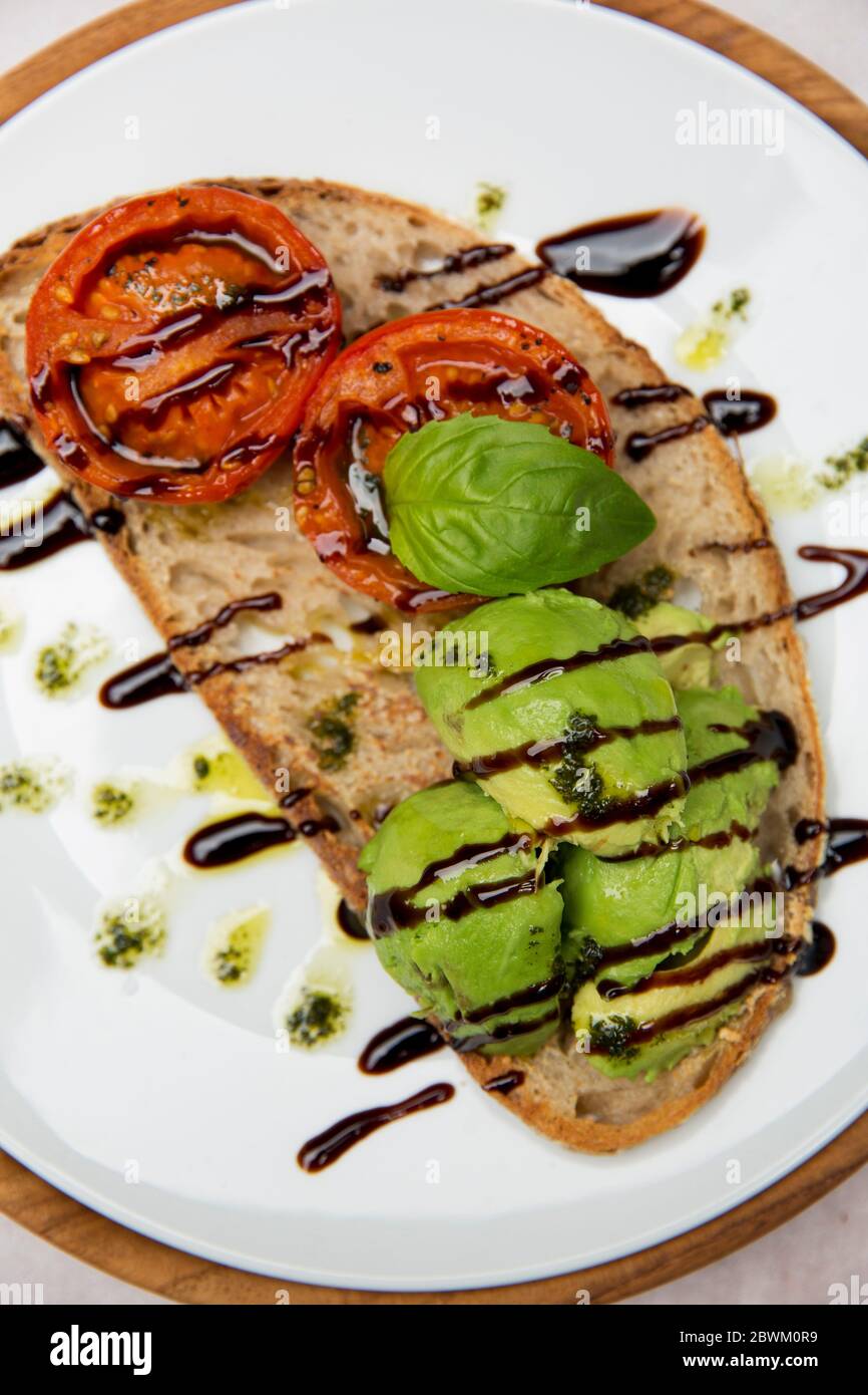 High Angle Close Up Of Tomato And Avocado Bruschetta With Balsamic Vinegar Reduction In A Cafe Stock Photo Alamy