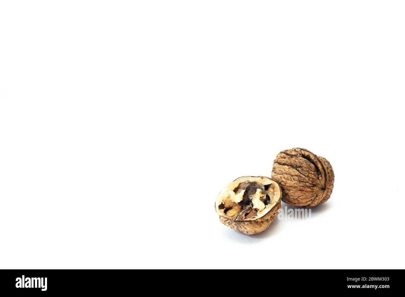 Opened walnut half and whole walnut on white background Stock Photo Alamy