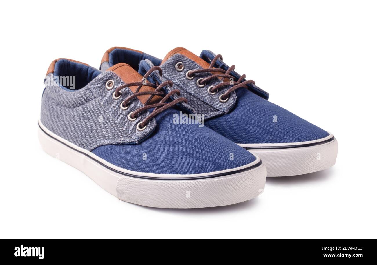 Pair of new blue sneakers isolated on white background Stock Photo - Alamy