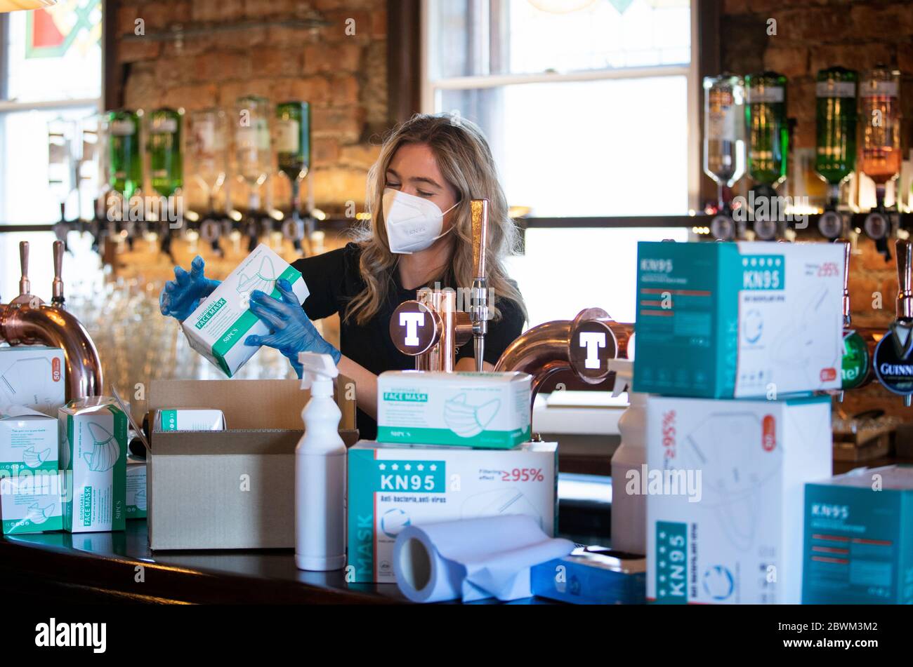 Hannah Young packs PPE items in Malones bar, Edinburgh. The bar is part of the Rosslyn North group that have switched to selling and distributing PPE as Scotland is moving into phase one of the Scottish Government's plan for gradually lifting lockdown. Stock Photo