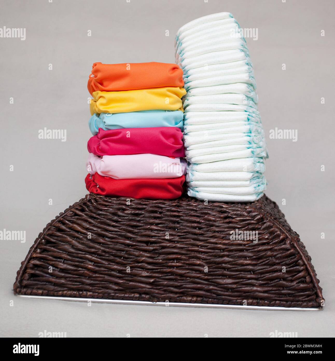 Stacks of disposable diapers and modern cloth diapers together Stock ...