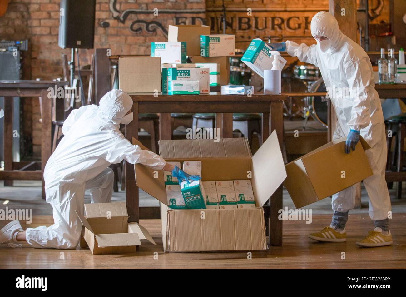 Hannah Young (left) and Danny McCormick pack PPE items in Malones bar, Edinburgh. The bar is part of the Rosslyn North group that have switched to selling and distributing PPE as Scotland is moving into phase one of the Scottish Government's plan for gradually lifting lockdown. Stock Photo