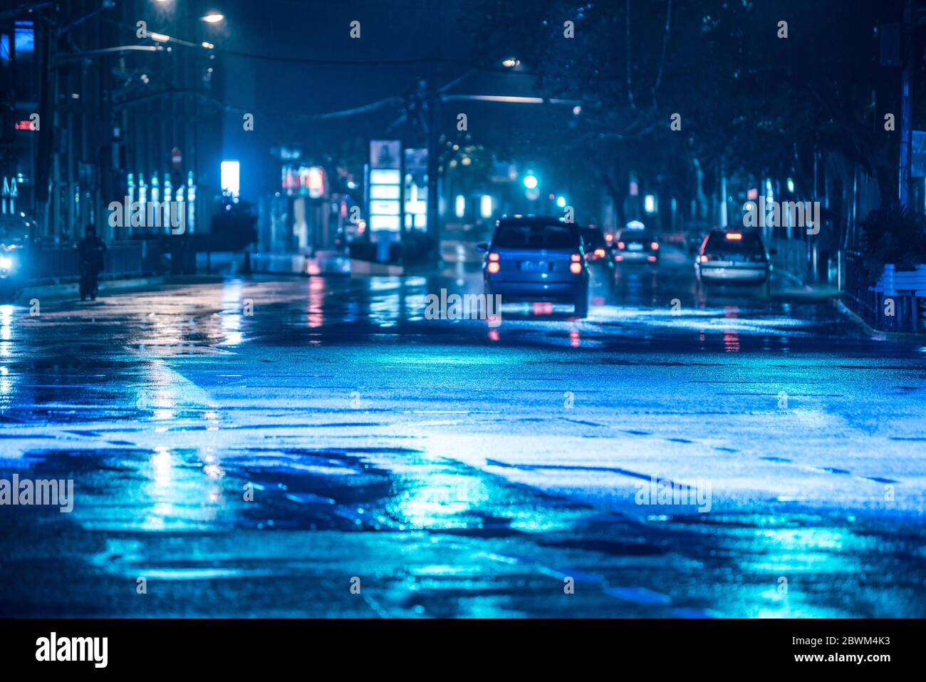 Late night drive through city with reflections of headlights