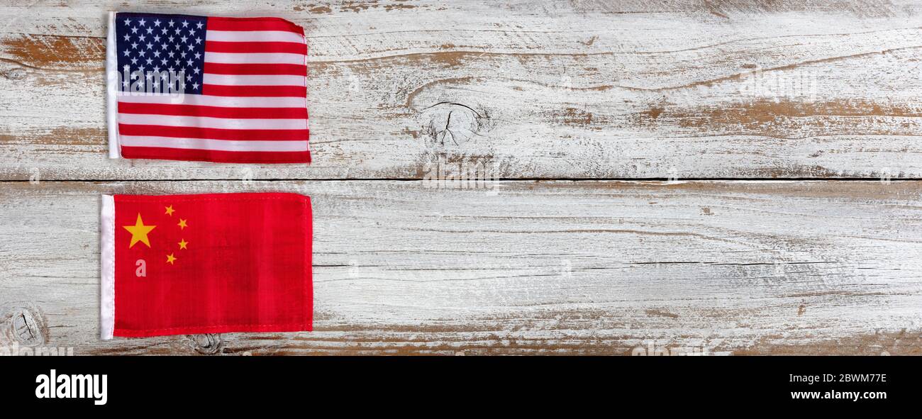 National flags representing China and the United States of America on white rustic wooden background. Trade war concept Stock Photo