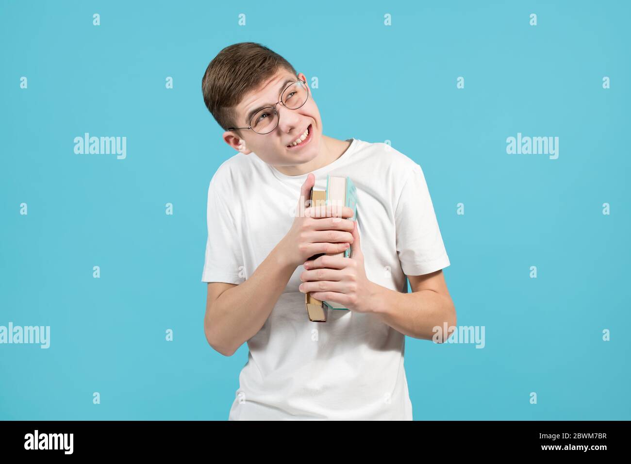 nerd with fear and caution looks up, squinting and holding books to