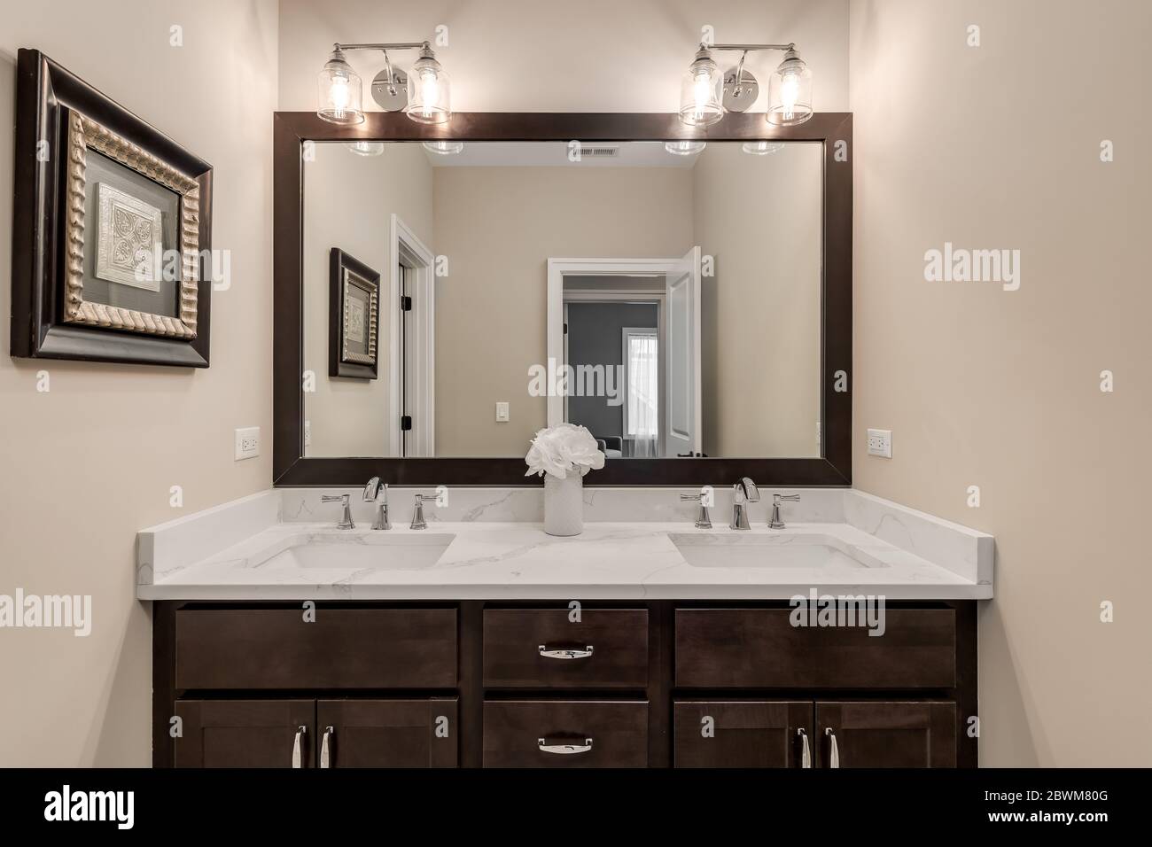 A Small Bathroom With A Dark Vanity And Cream Colored Granite Counter Top Stock Photo Alamy