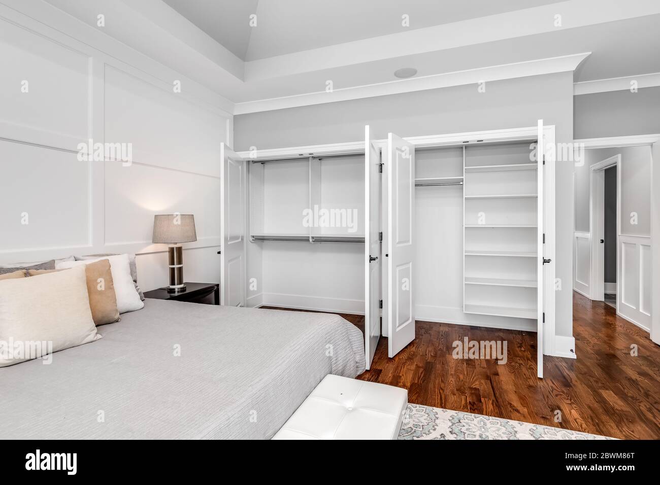 Image showcasing A neutral colored, large master bedroom with high ceilings and molding ...