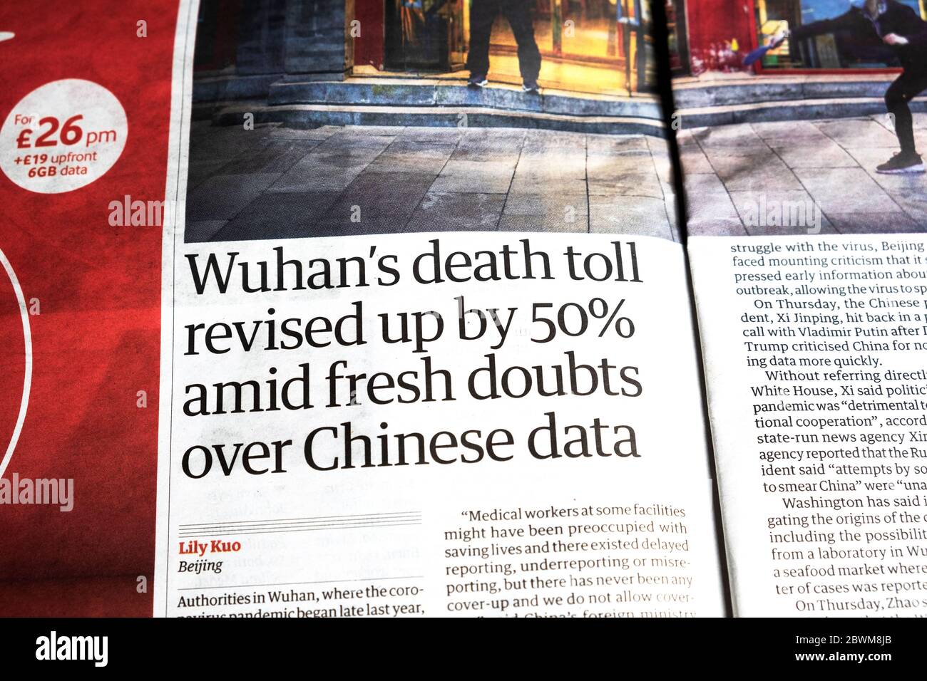 'Wuhan's death toll revised up by 50% amid fresh doubts over Chinese data' article in Guardian newspaper headline18 April 2020 Stock Photo