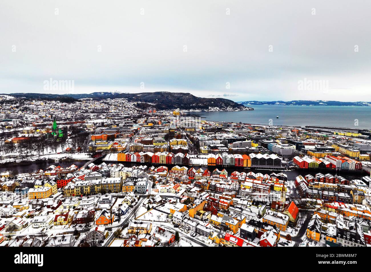 Trondheim, Norway. Aerial view of the city center in winter in Trondheim, Norway with snow, river and historical colorful buildings Stock Photo