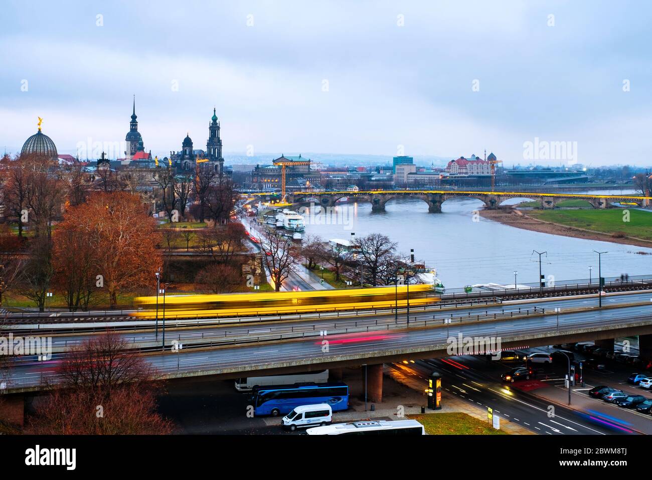 Dresden, Germany. Aerial view at main illuminated landmarks in the city of Dresden, Germany at sunset. Car traffic and reflection in the river, cloudy Stock Photo