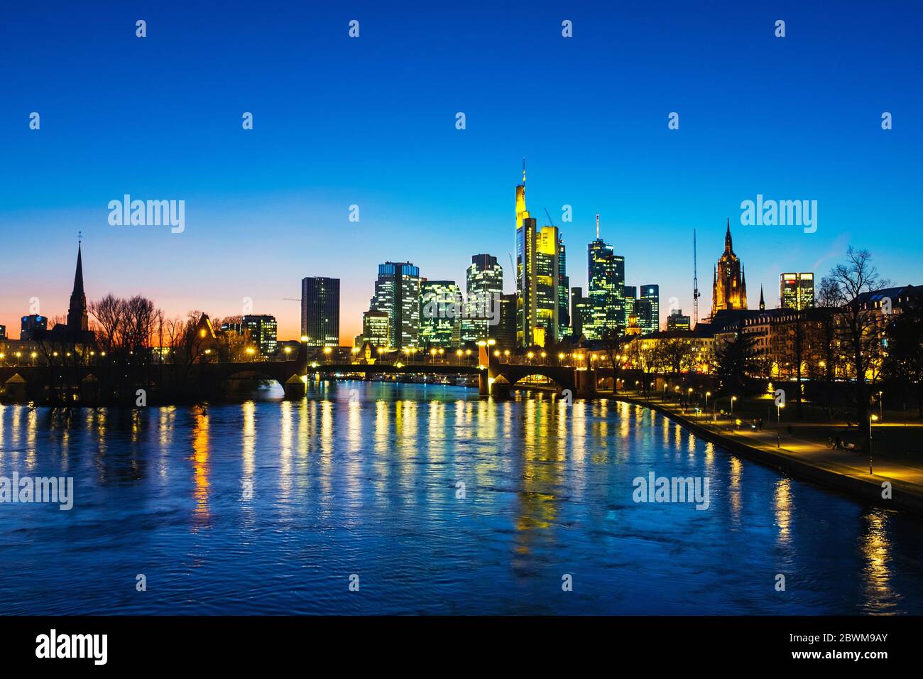 Frankfurt am Main, Germany. Skyline of Frankfurt, Germany in the sunset with famous illuminated skyscrapers and river at night Stock Photo