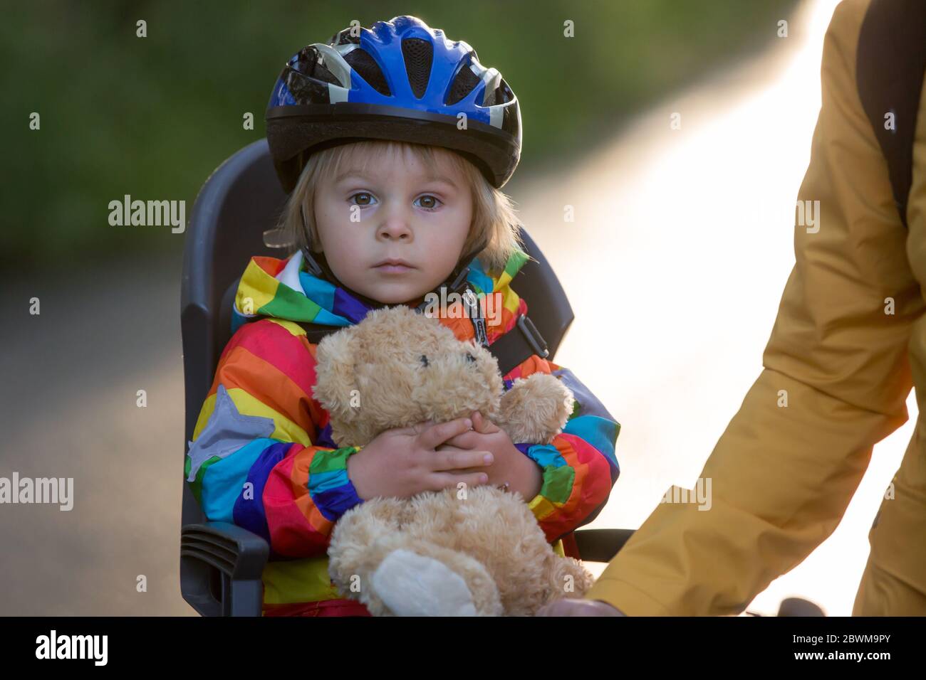 Mother and child, riding bike, boy sitting in bike seat, enjoying trip ...