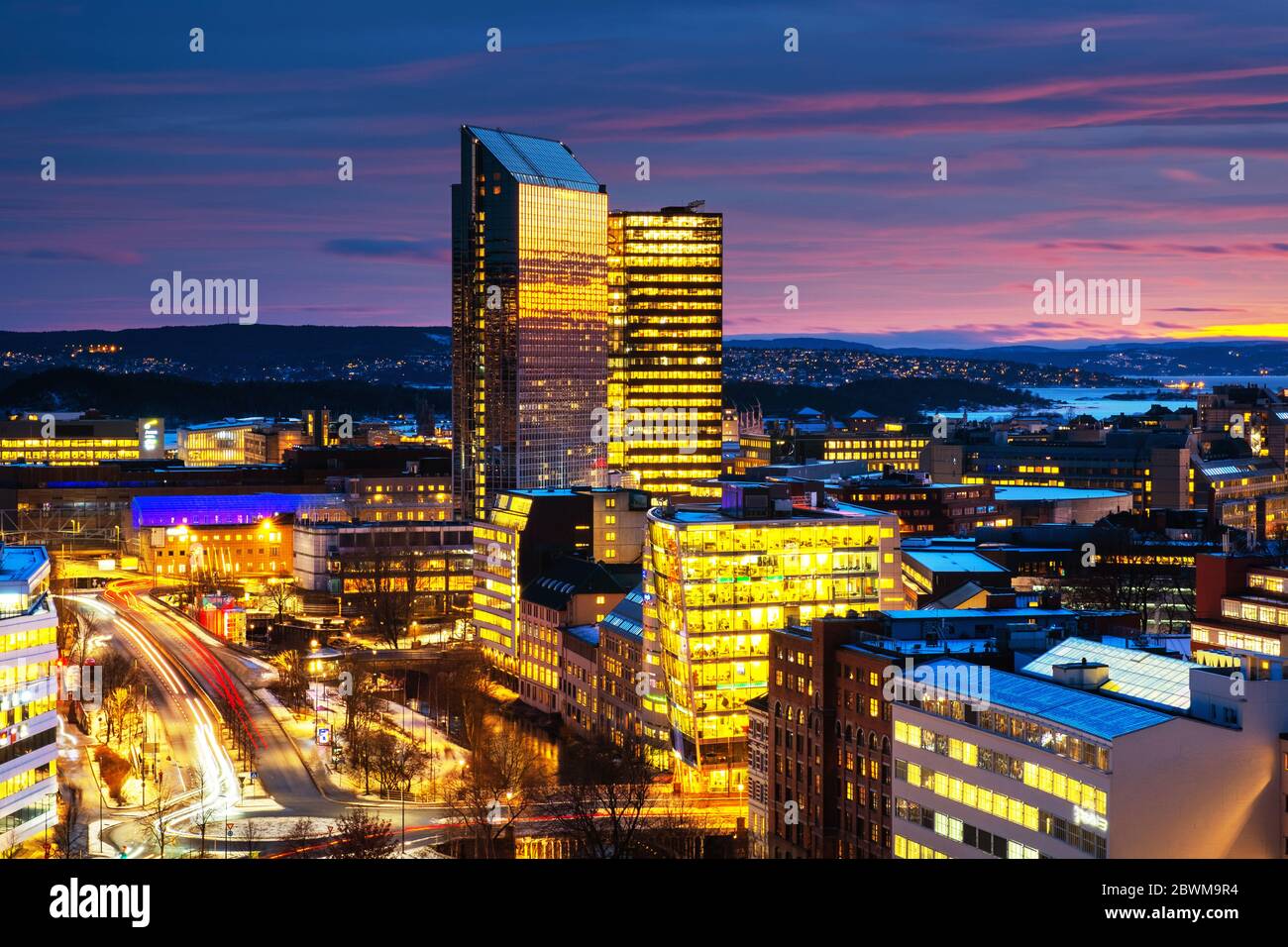 Oslo, Norway. A night view of Sentrum area of Oslo, Norway, with modern and historical buildings and car traffic. Sunset colorful sky in winter with s Stock Photo
