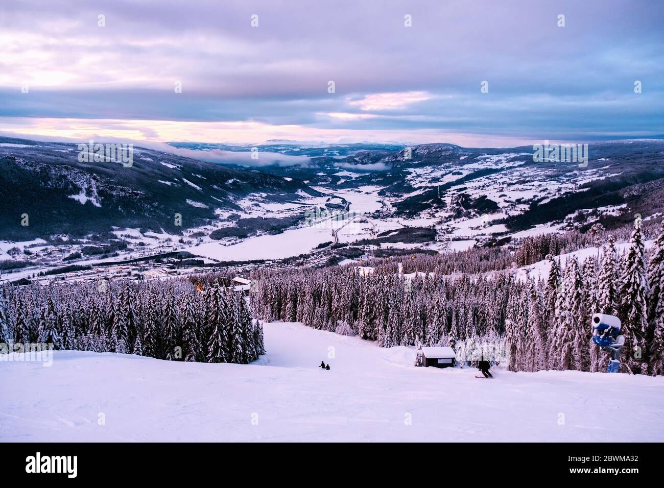 Hafjell, Norway. Aerial view of ski resort Hafjell in Norway with skiers going down the snowy slopes in winter with mountains Stock Photo