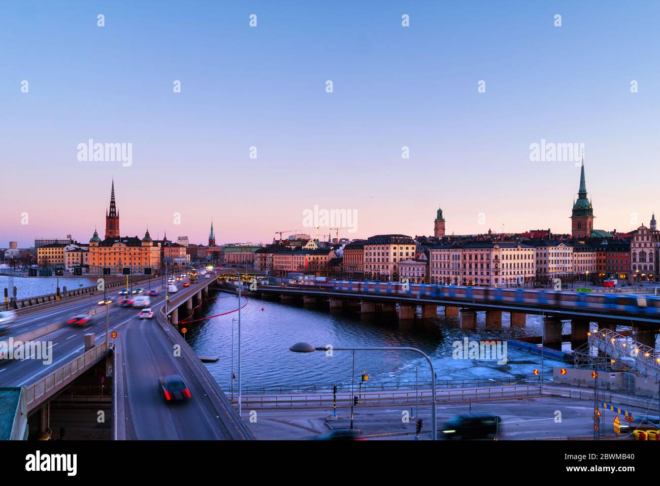 Stockholm, Sweden. Gamla Stan in Stockholm, Sweden with landmarks like Riddarholm Church during the morning. View of old buildings and car traffic at Stock Photo