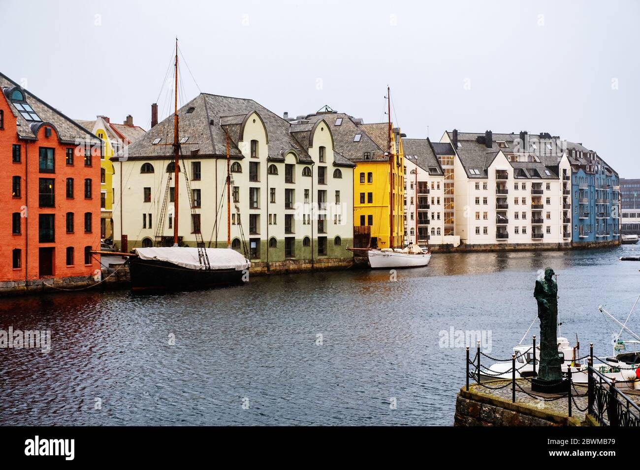Alesund, Norway. View of center of Alesund, Norway during the winter. Cloudy sky over the famous touristic destination with mountains at the backgroun Stock Photo