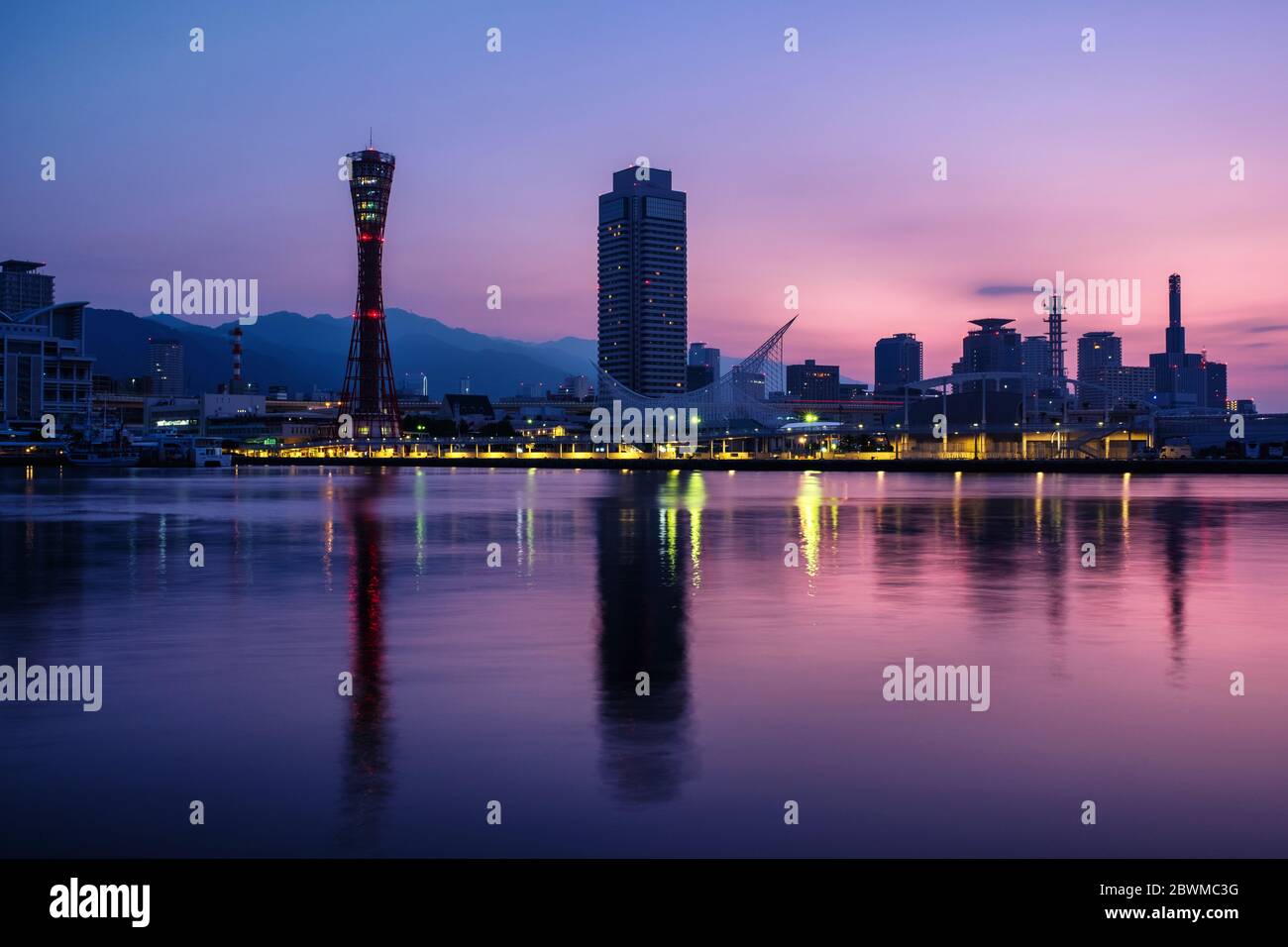 Kobe, Japan. View of sunrise in Kobe, Japan. Cloudless sky with harbor and numerous skyscrapers and Port Tower Stock Photo