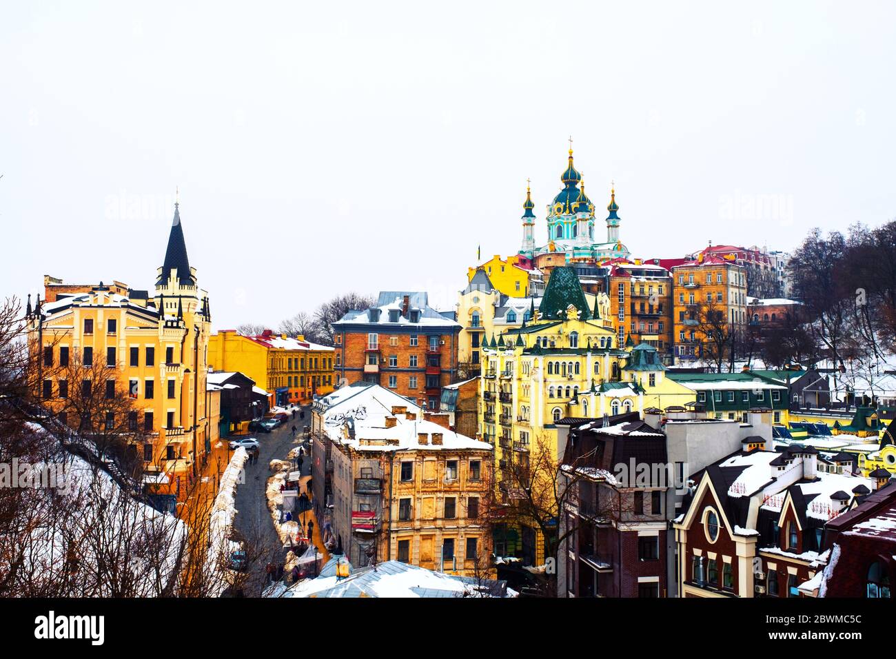 Kyiv, Ukraine. View of Andrew's descent in winter during the cloudy moody day. Snow over the mountain, famous St Andrew church in Kyiv, Ukraine Stock Photo