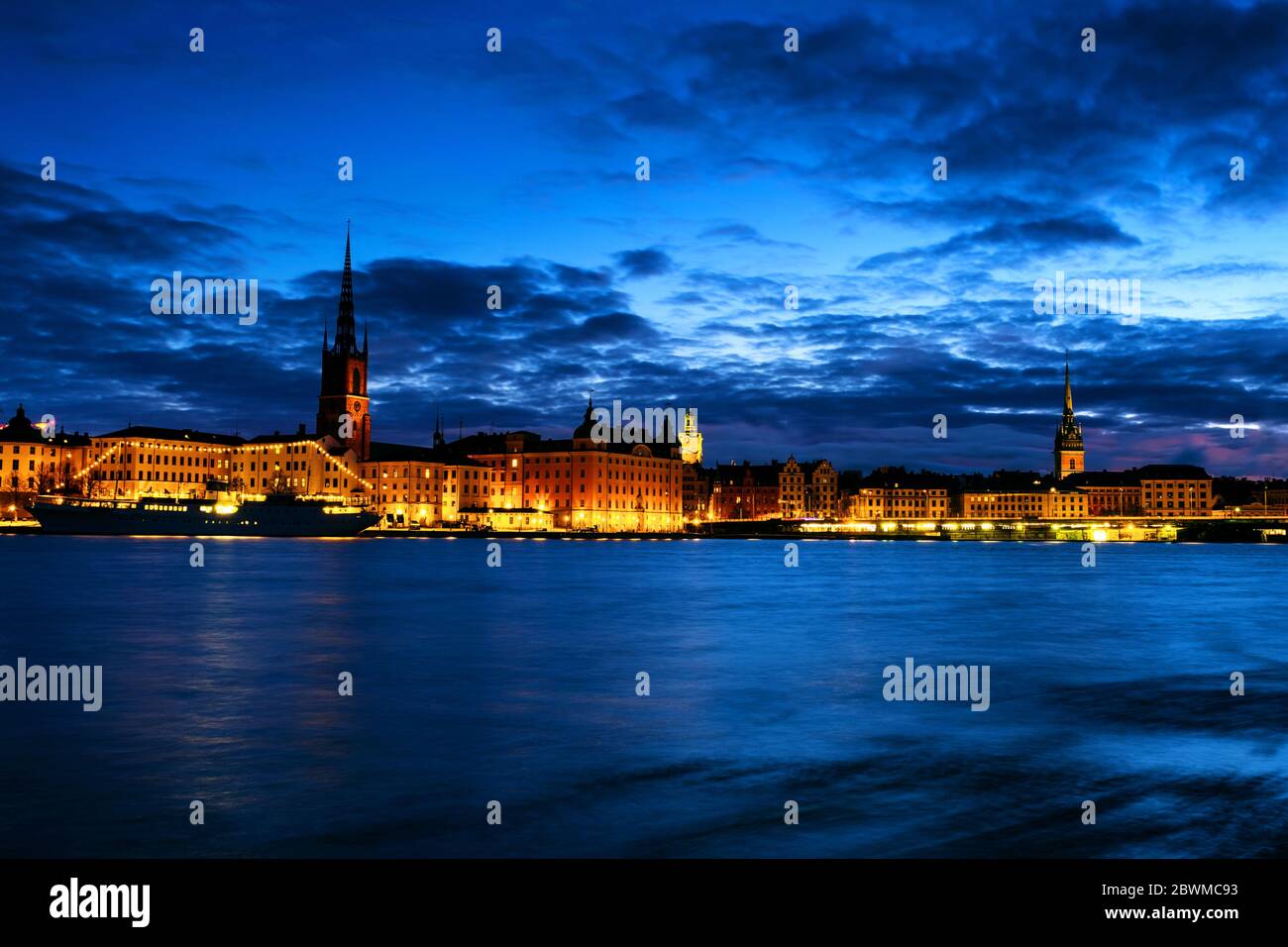 Stockholm, Sweden. View of Gamla Stan in Stockholm, Sweden with landmarks like Riddarholm Church during the night. View of old buildings and car traff Stock Photo