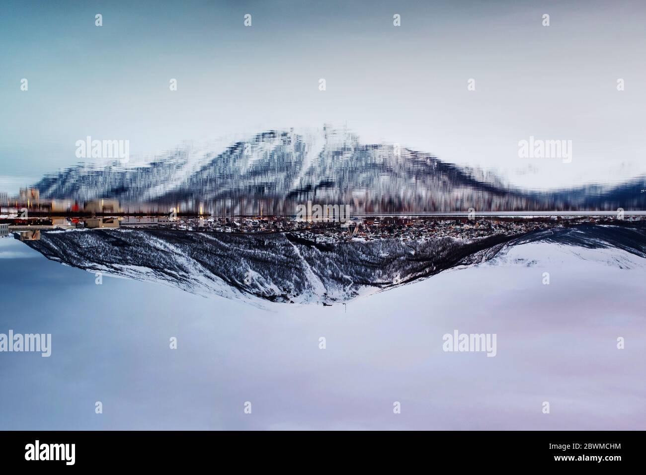 Tromso, Norway. Morning view of famous north town Tromso, Norway. View of the fjord with houses and mountain, cloudy sunrise sky Stock Photo