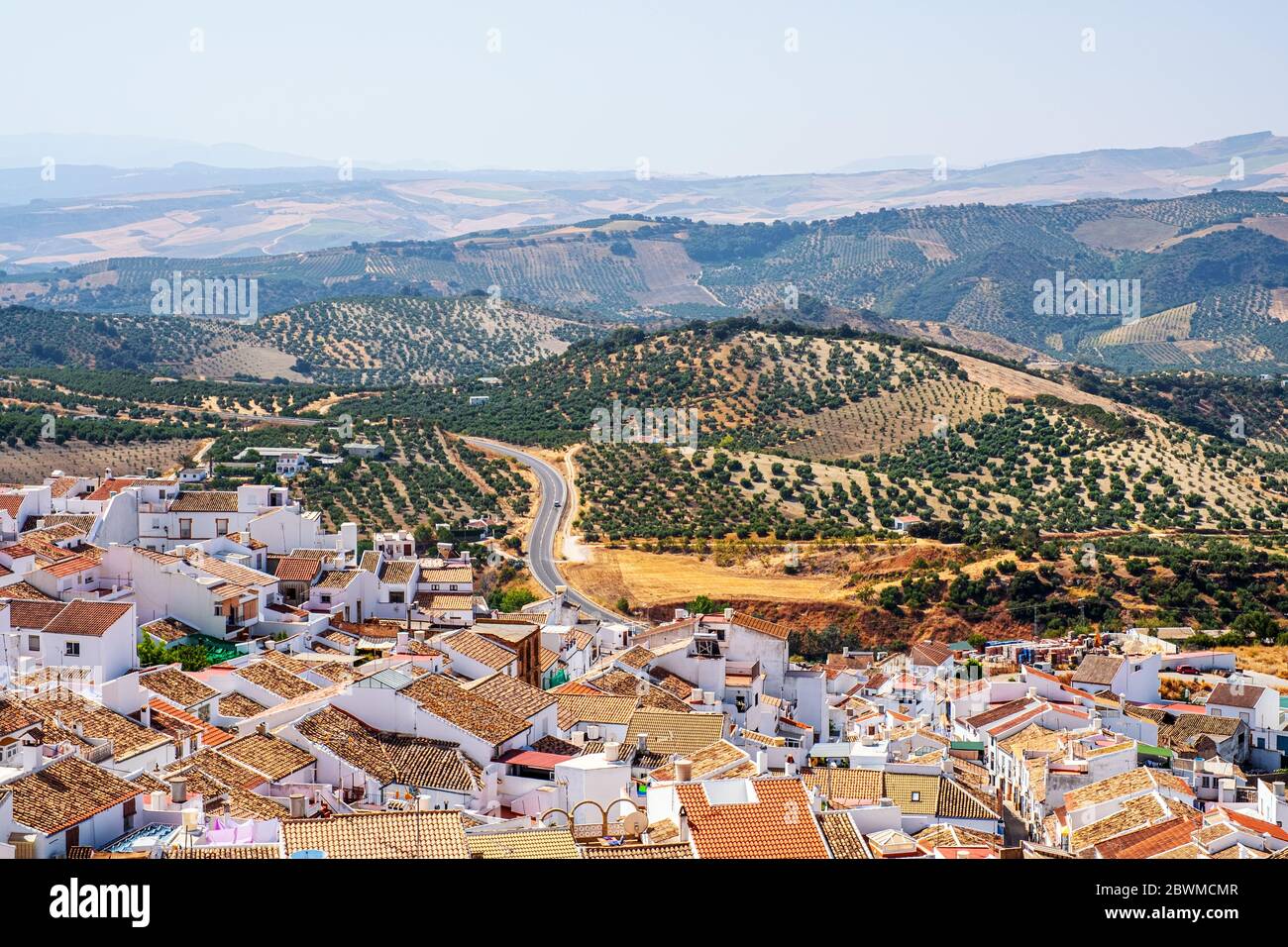 Olvera, Spain. Aerial view of old touristic town Olvera, Spain surrounded by mountains. Dry landscape in hot summer, white houses in Spanish village Stock Photo