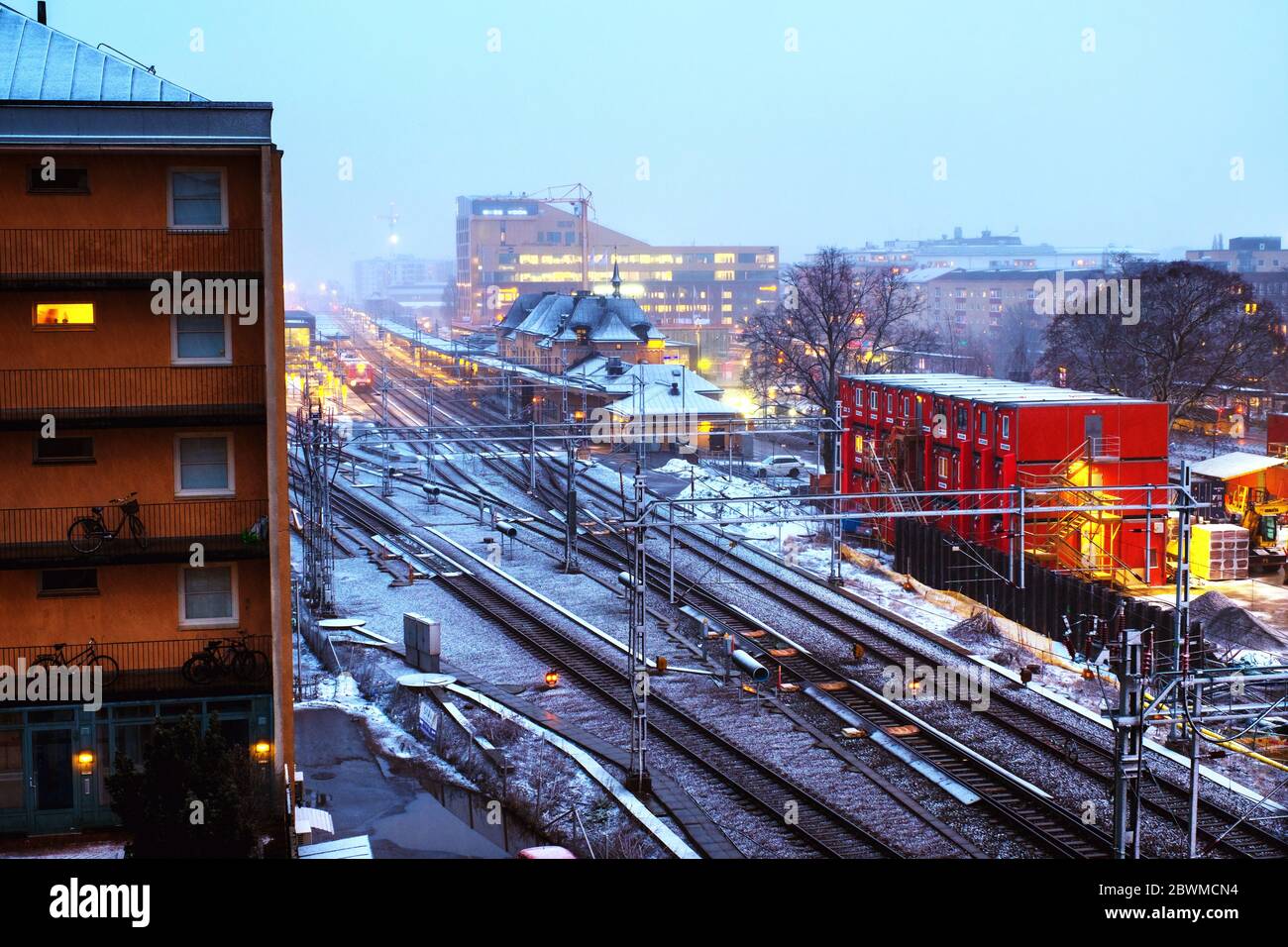 Uppsala, Sweden. Aerial view of railway station in Uppsala, Sweden at sunset. Snowy evening with train traffic and cloudy sky Stock Photo