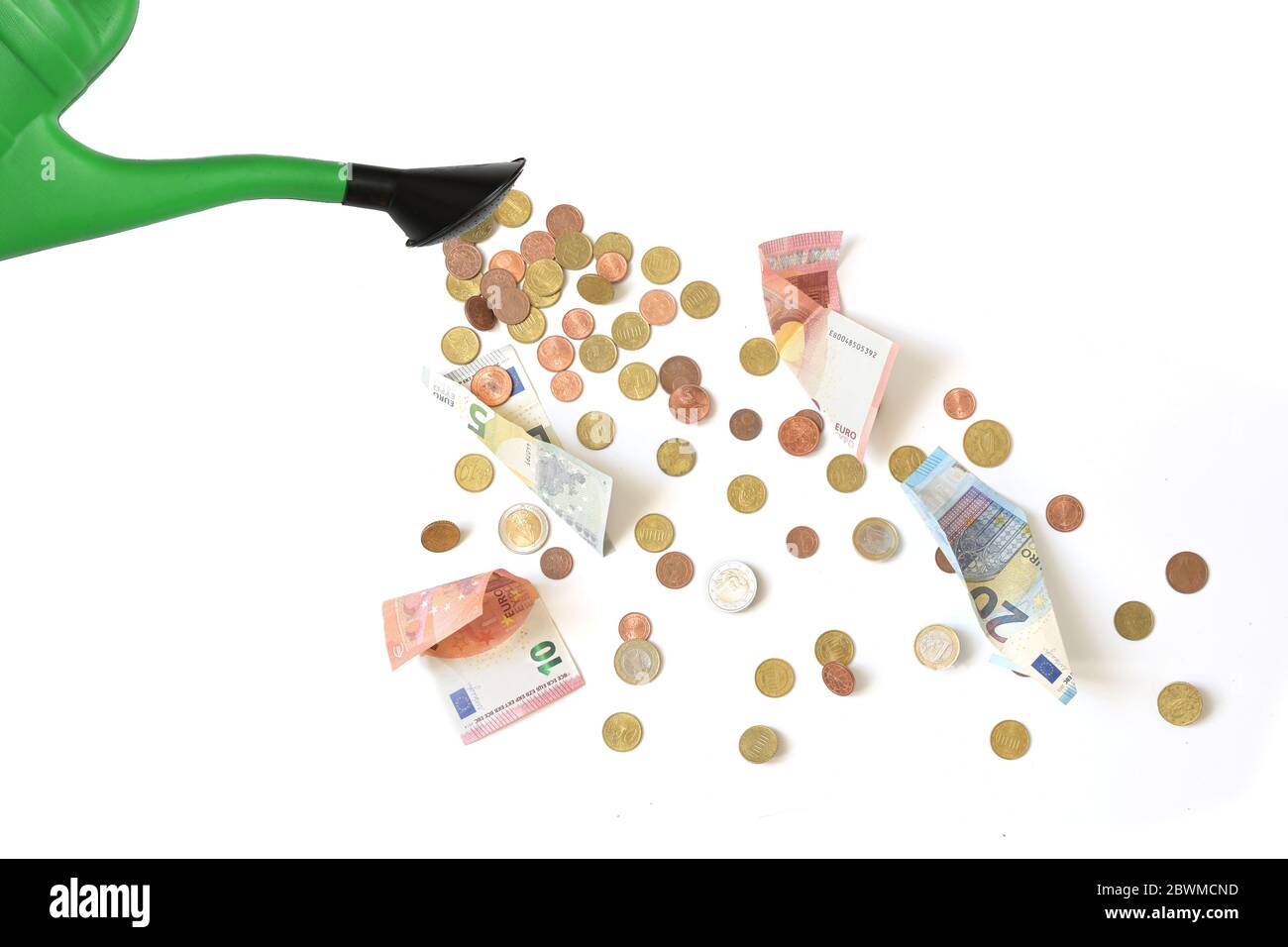 Green watering can is pouring Euro coins and banknotes, dumping money at random or spreading subsidies and grants too thinly is called watering can pr Stock Photo