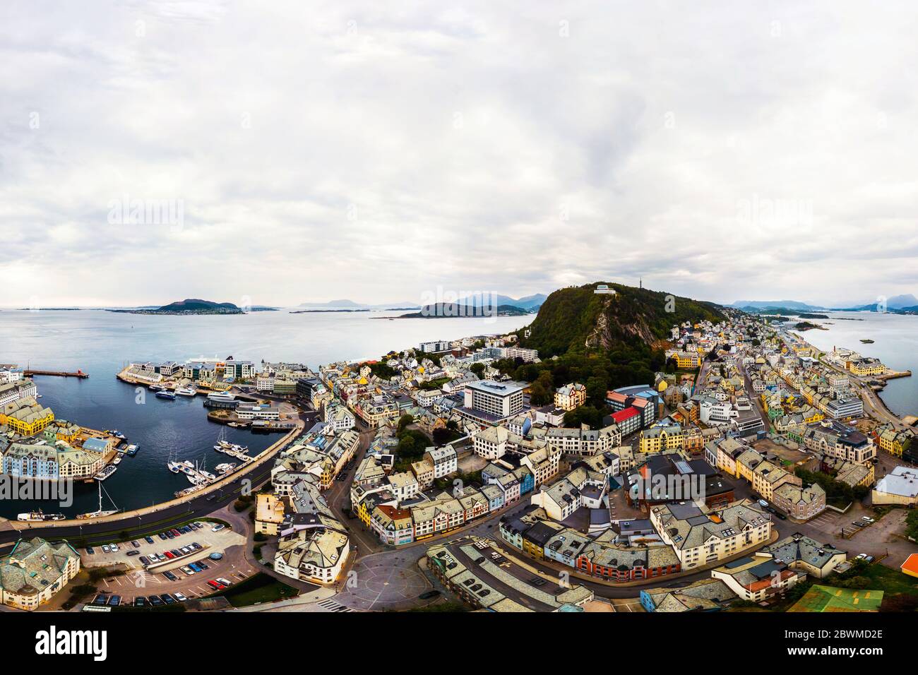 Alesund, Norway. Aerial view of Alesund, Norway during the rainy day. Cloudy sky over the famous touristic destination with mountains Stock Photo