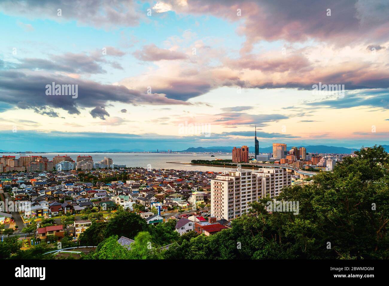Fukuoka, Japan. A sunset with a view of central Fukuoka, Japan, with tall modern buildings standing by the Hakata Bay on a cloudy summer night Stock Photo