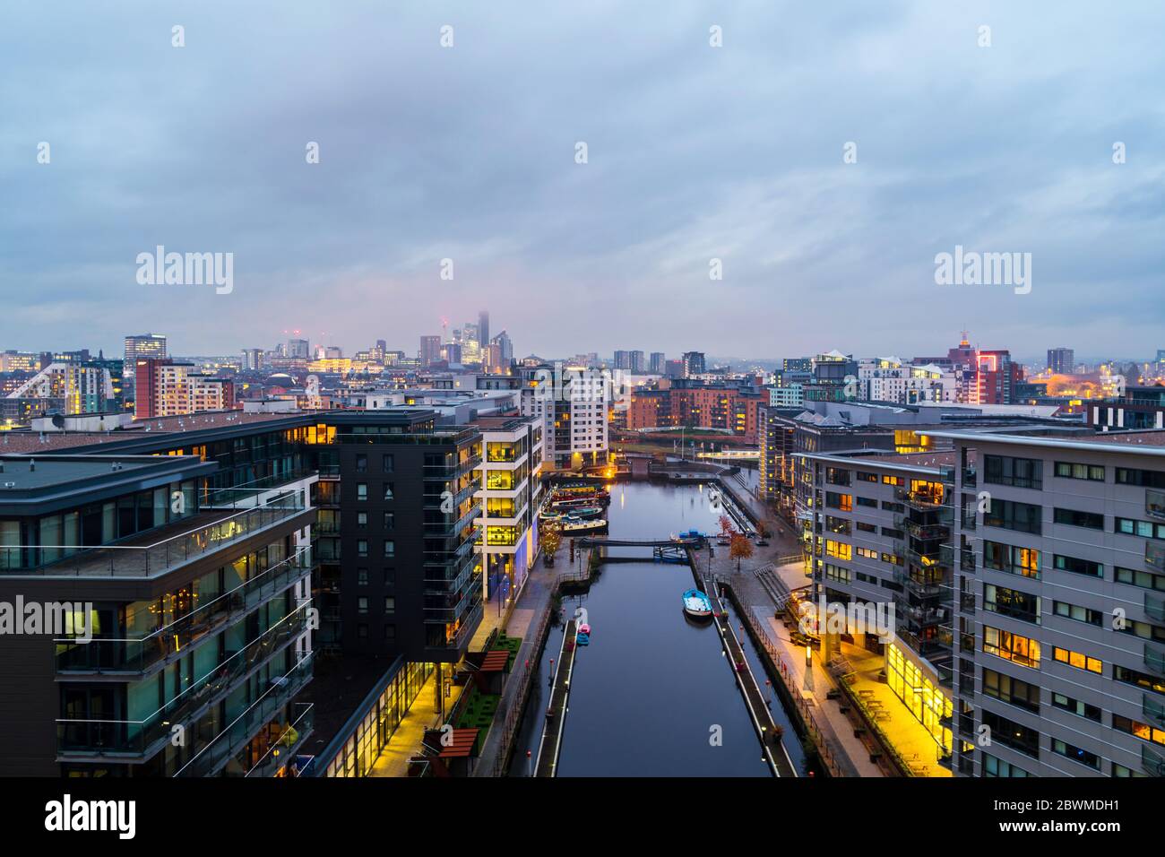 Leeds, UK. Aerial view of Leeds docks, England, UK during the sunset. Heavy clouds over the modern buildings, apartments in the evening and night Stock Photo