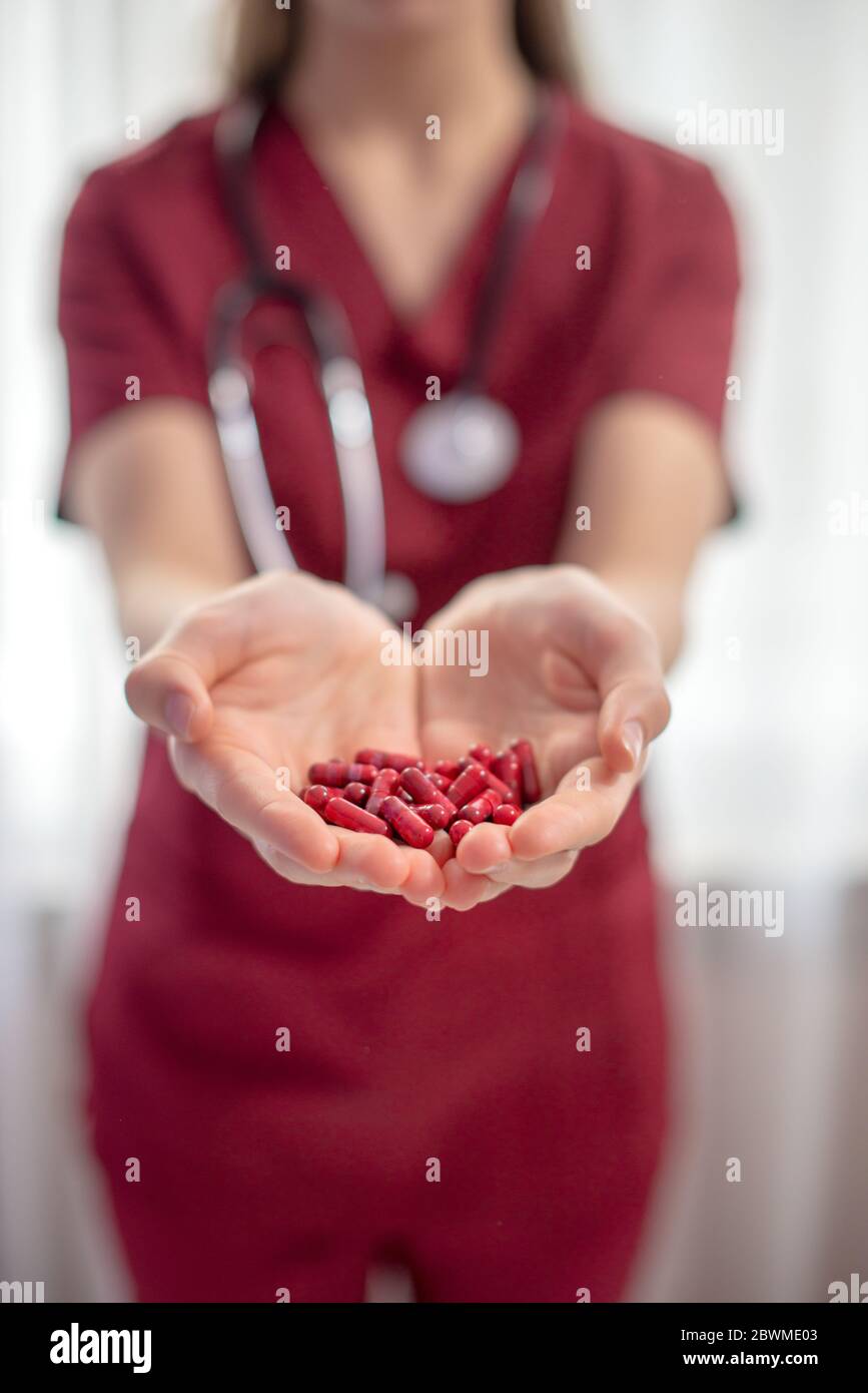 Woman doctor giving pills witch represent oral vaccine Stock Photo