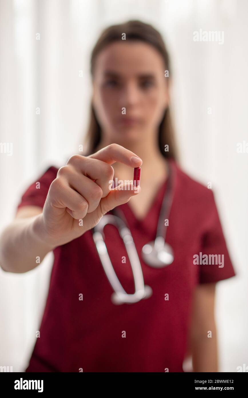 Woman doctor giving pills witch represent oral vaccine Stock Photo