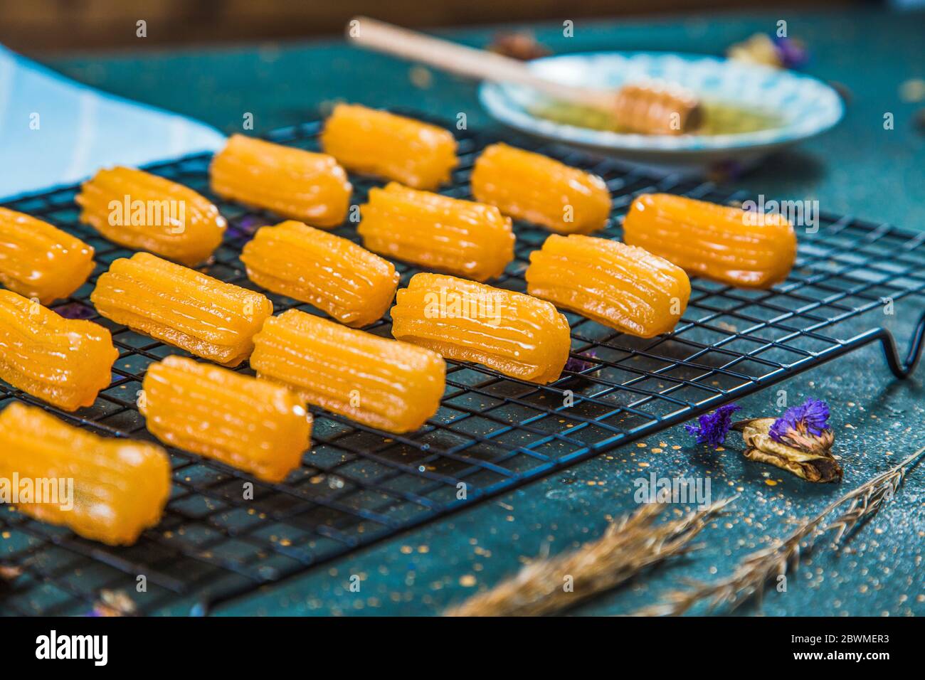 Side view of syrupy dessert tulumba arranged on grid Stock Photo Alamy