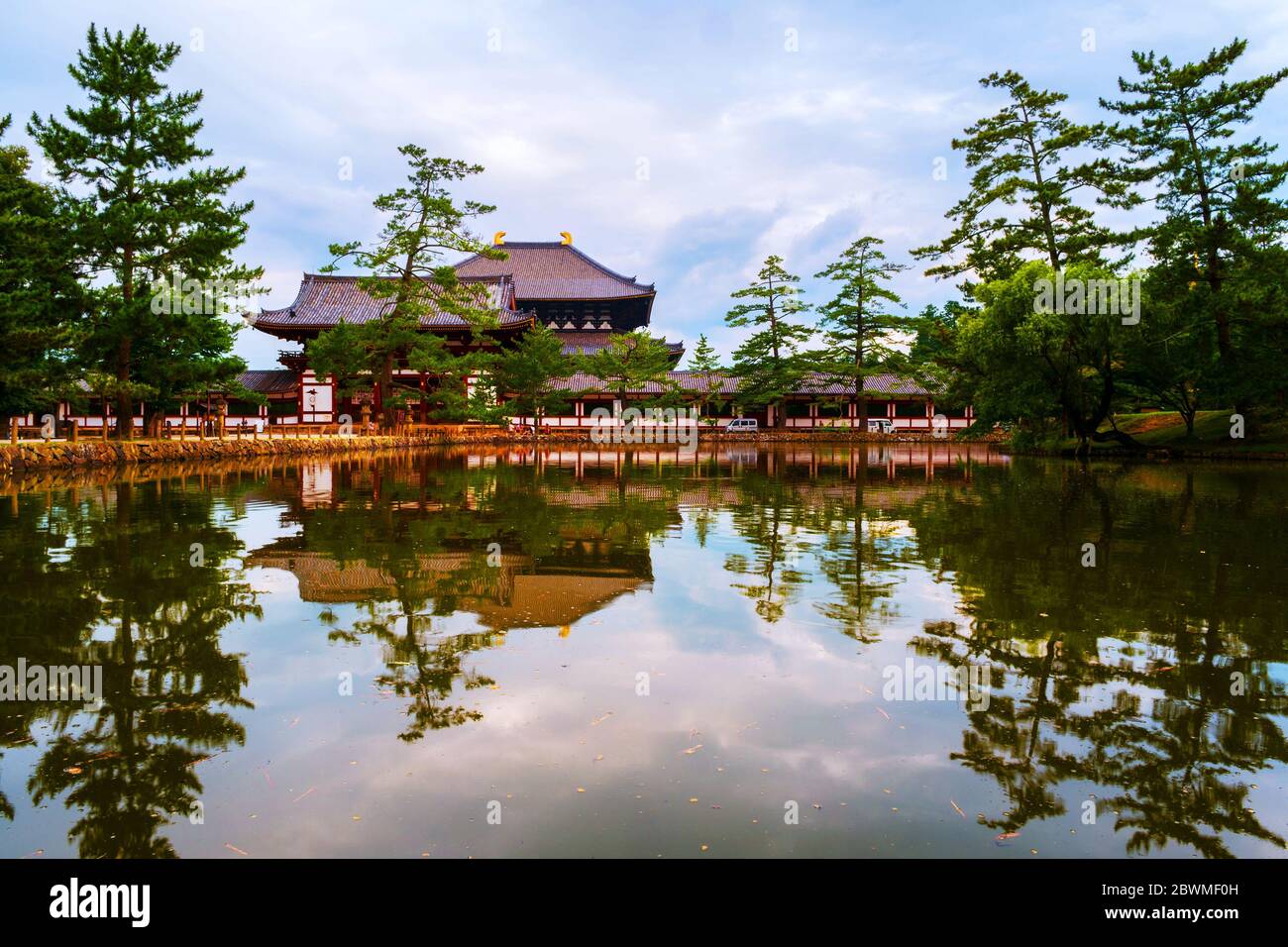 Nara, Japan. View of the Todaiji Nakamon temple in Nara, Japan. Famous landmark in summer with reflection in the pond. Cloudy sky during the day Stock Photo
