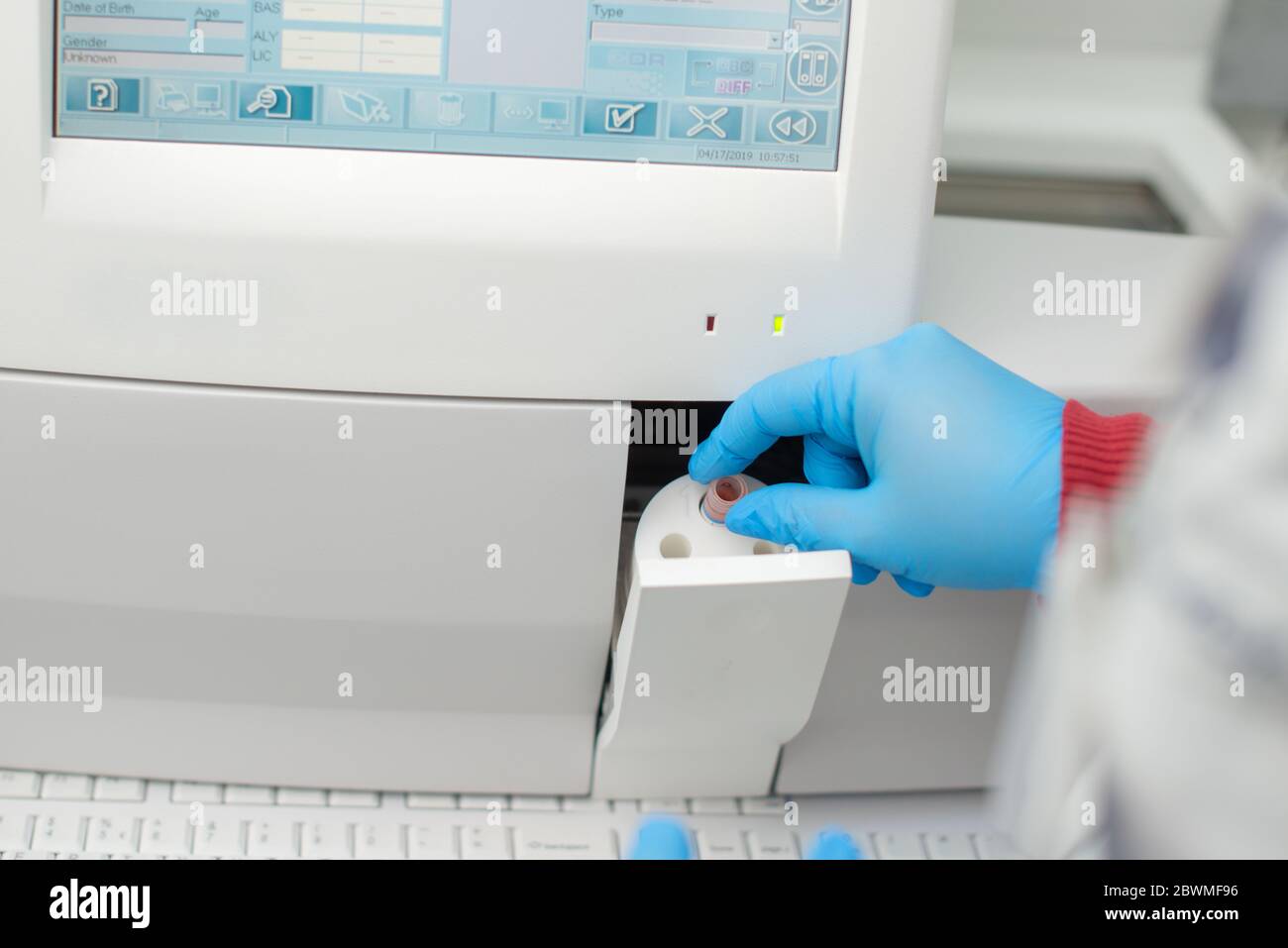 Biochemist checking a blood test to see if is positive to coronavirus Stock Photo