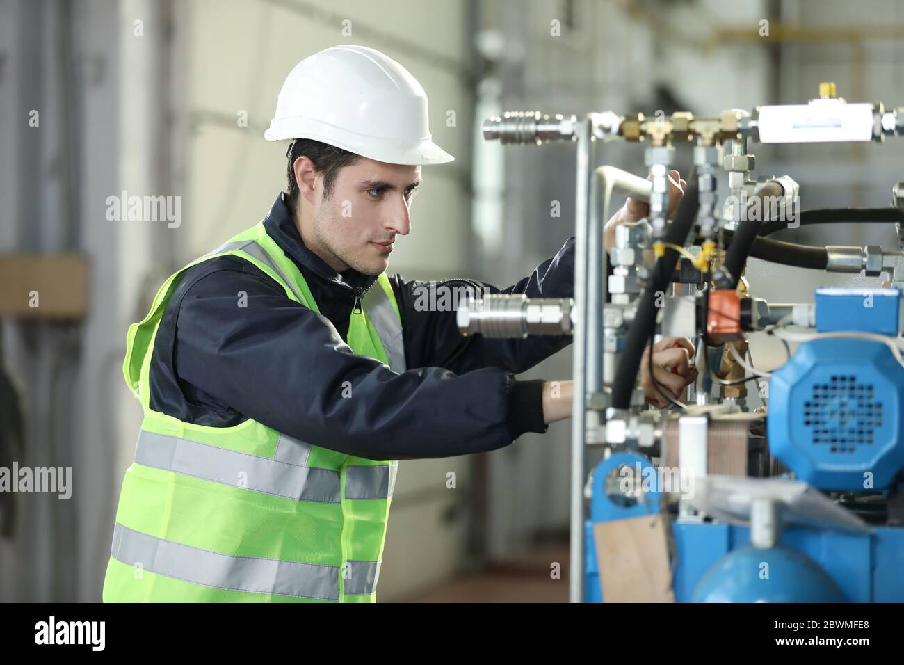 Work Clothes Engineer Portrait of a man , factory engineer in work clothes controlling the ...